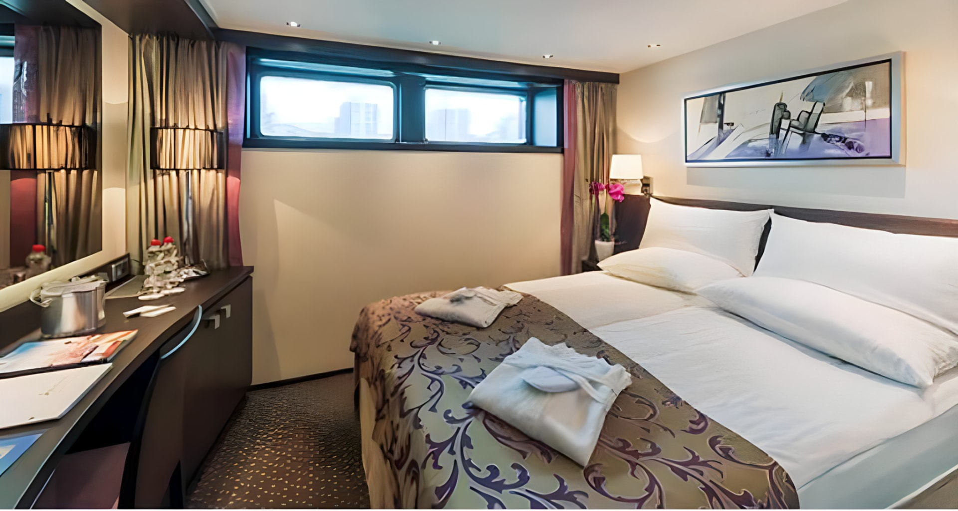 A stateroom with a king bed and river-view windows