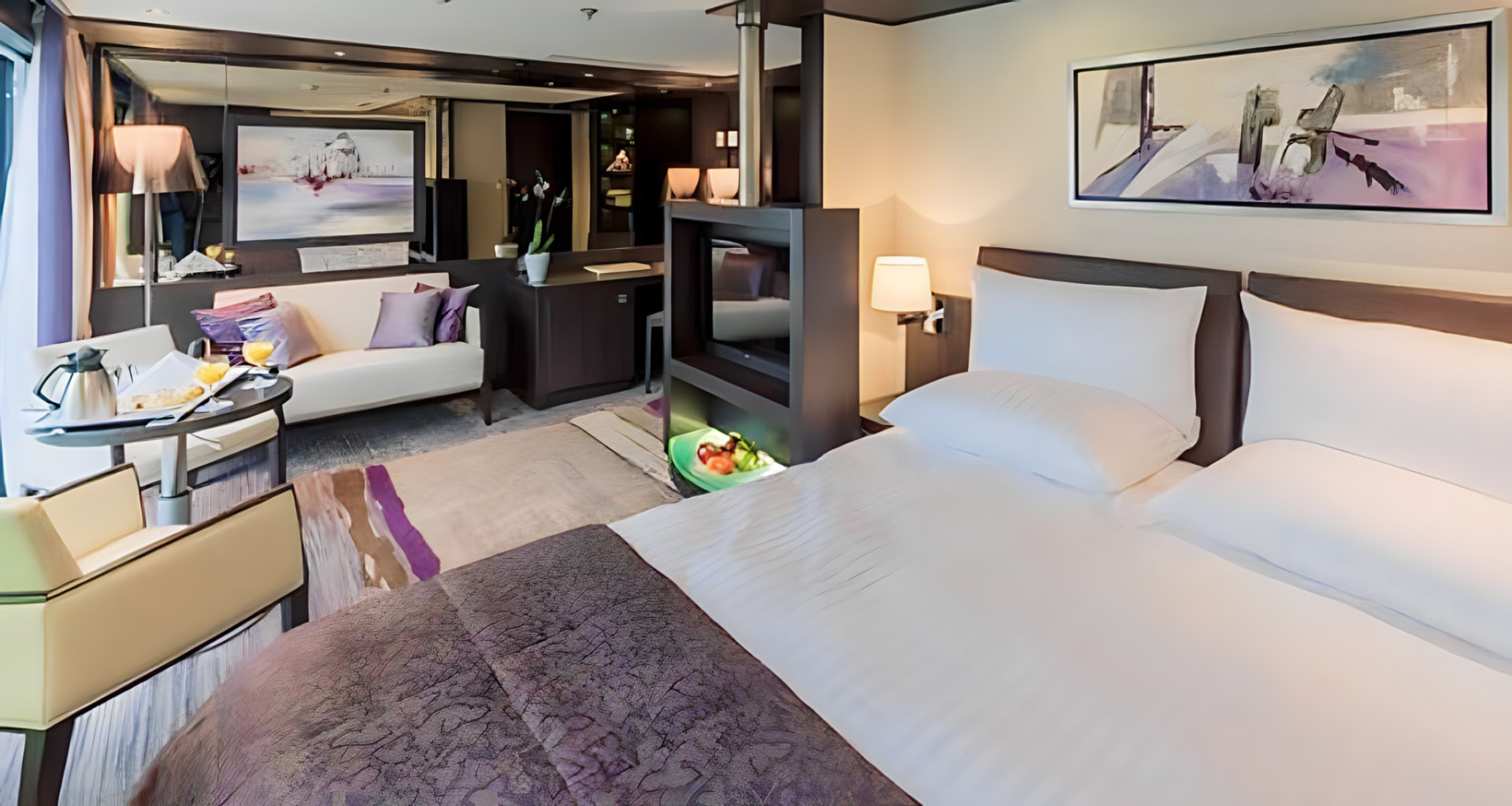 A suite with a king bed and sitting area