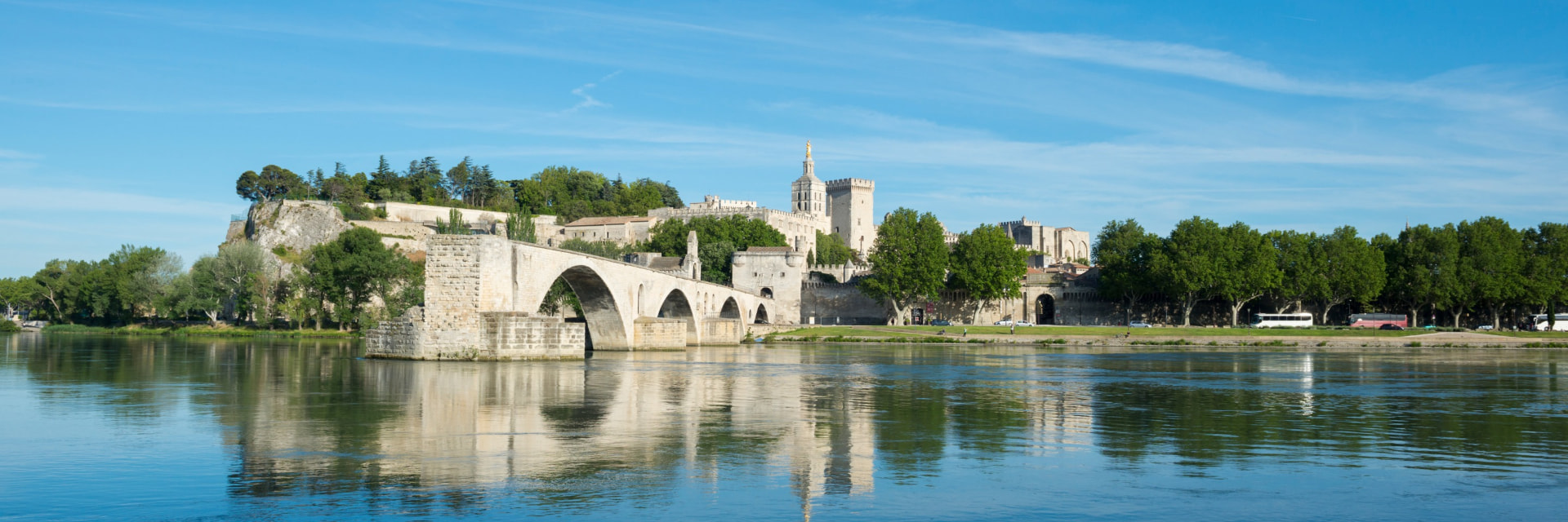 Panorama of Avignon, its ramparts and the Pont Saint-Bénézet reflected in the Rhône